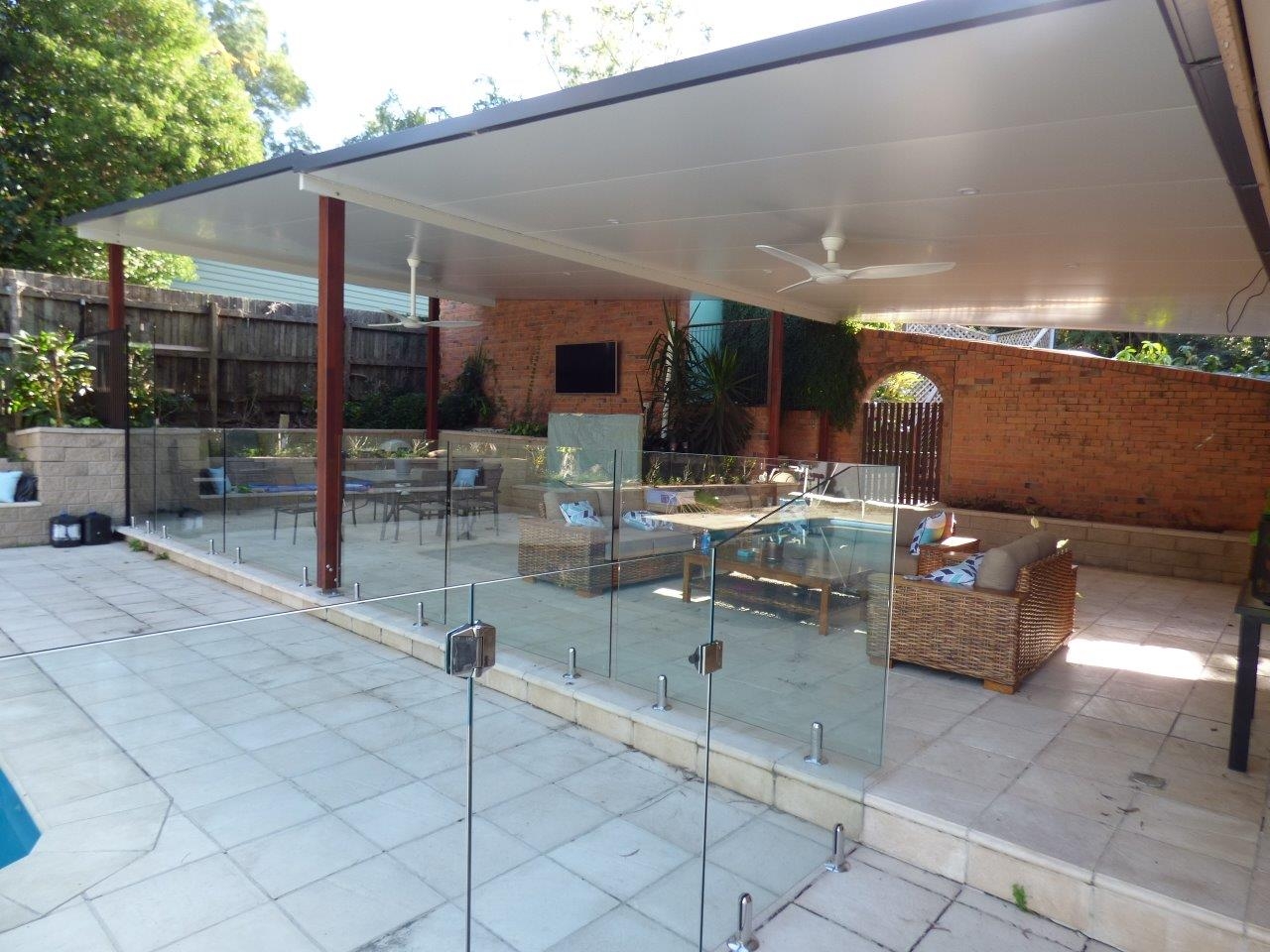 Pool patio with glass fencing.