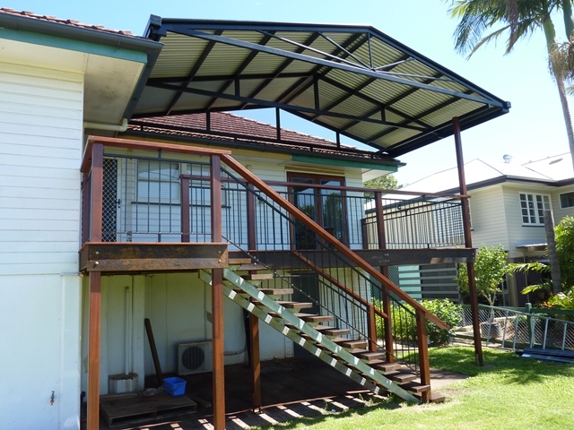 High set patio roof with timber staircase.