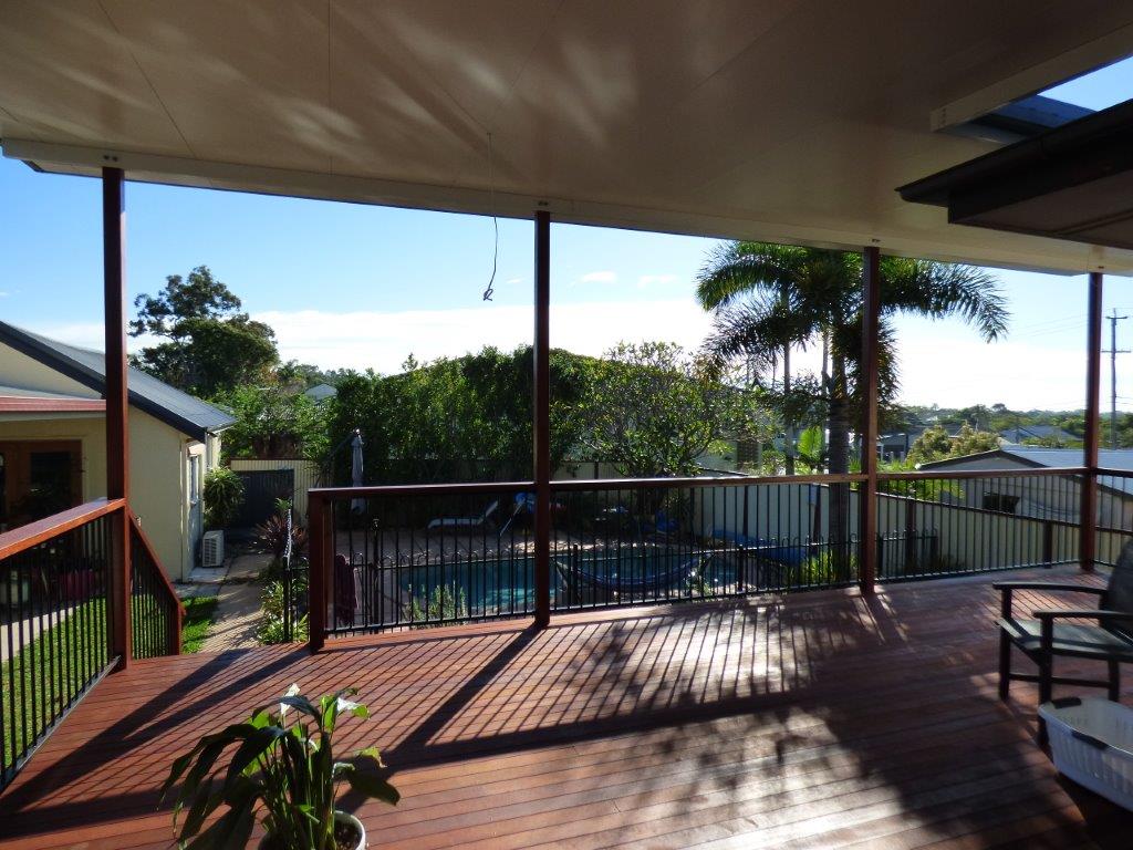 This is a lovely deck with flyover roof overlooking the pool.