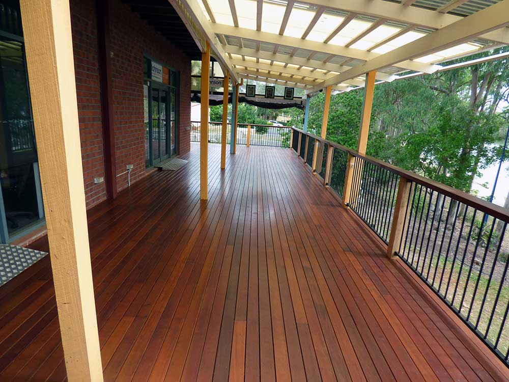 Commercial Property - Café and Real estate Agents in Forest Lake, Brisbane. Building overlooks the lake. Re-build in Kwila decking. Kwila hand rail with powder coated aluminium balustrade. #premiumlifestyles #commercialdecks