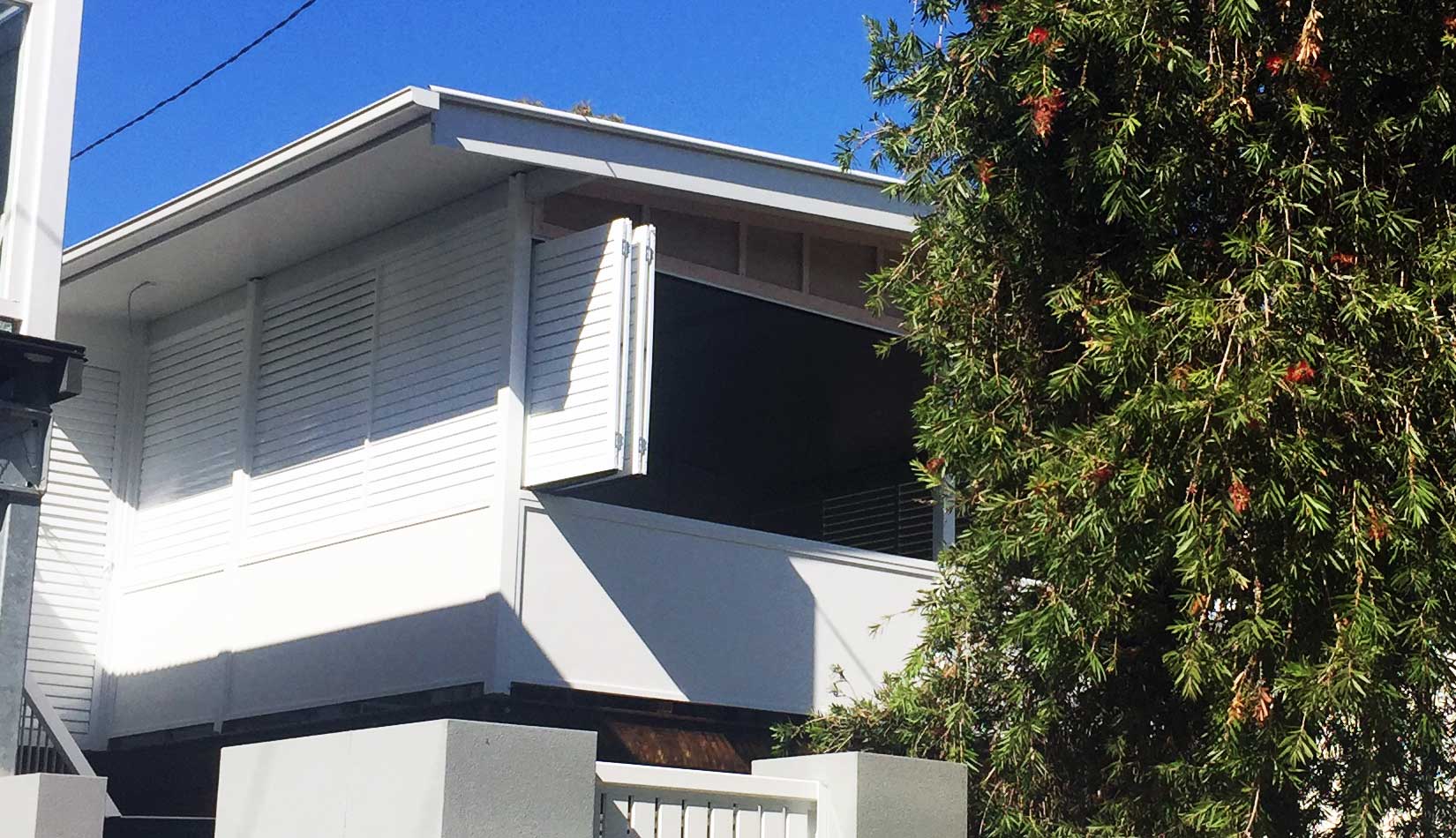 Patio with deck and roof extension mad with weather walls.